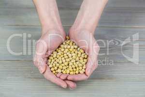 Woman showing handful of chickpeas