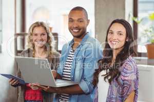 Happy business people using technologies in office