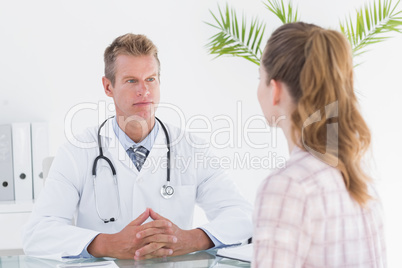 Serious doctor listening his patient