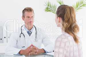 Serious doctor listening his patient