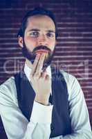 Portrait of serious hipster with hand on chin