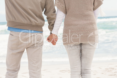 Happy couple holding hands while walking