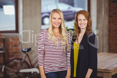 Portrait of smiling women standing in office