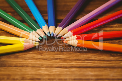 Colour pencils on desk in circle shape