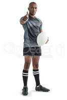 Portrait of confident rugby player showing thumbs up while stand