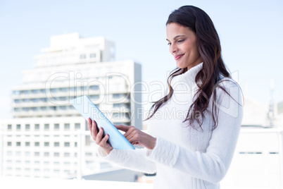 Smiling woman using tablet pc Smiling woman using tablet pc