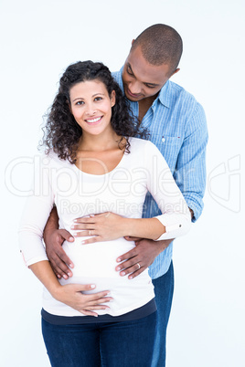 Happy pregnant woman with man against white background