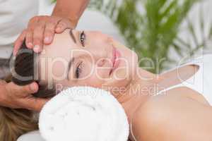 Happy woman receiving neck massage