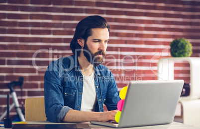 Confident businessman using laptop