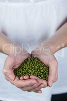 Woman showing handful of lentils