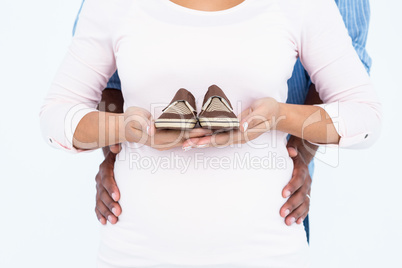 Midsection of woman carrying shoes with husband