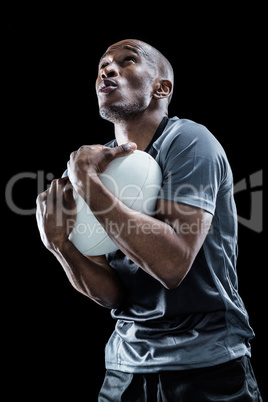 Rugby player catching ball while playing