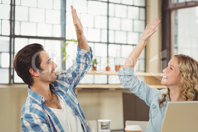 Colleagues giving high five