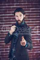 Portrait of confident man with smoking pipe pointing finger