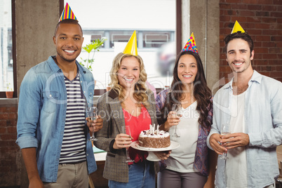 Portrait of happy colleagues standing in office