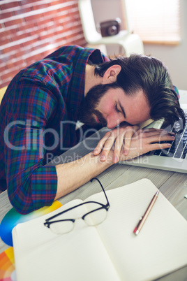 Tired creative businessman sleeping