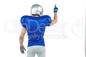 Rear view of American football player pointing