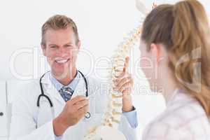 Doctor explaining anatomical spine to his patient