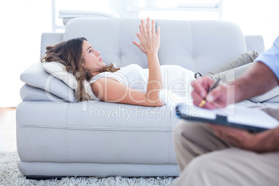 Preganant woman relaxing on sofa with therapist