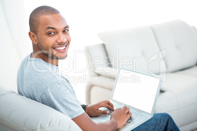 Portrait of happy man with laptop