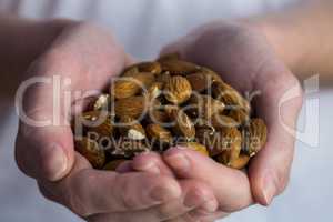 Woman showing handful of almonds