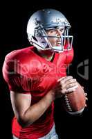 Aggressive American football player holding ball