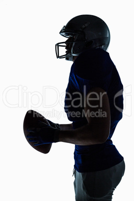 Side view of sportsman holding football