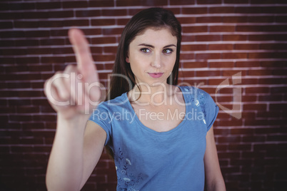 Pretty brunette pointing with finger