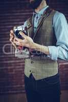 Midsection of man with camera