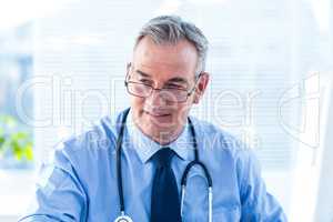 Male doctor looking away in clinic