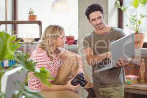 Businessman explaining colleague in office