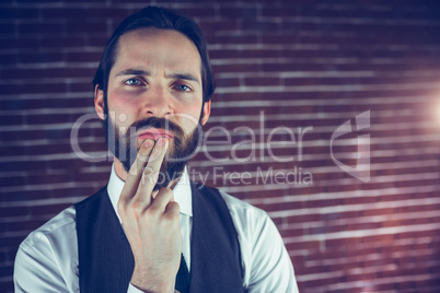 Portrait of thoughtful hipster with hand on chin