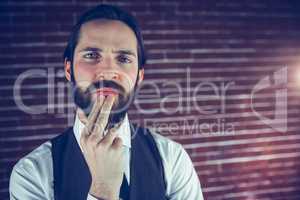 Portrait of thoughtful hipster with hand on chin