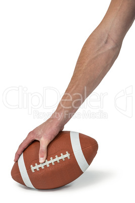 Close-up of American football player placing the ball
