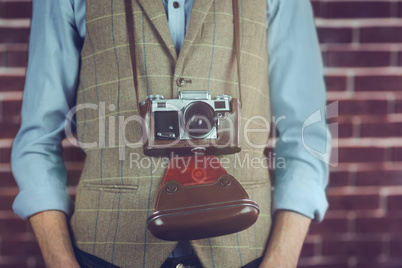 Midsection of hipster with camera