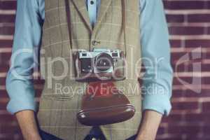 Midsection of hipster with camera