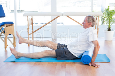 Man sitting on exercise mat