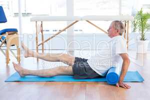 Man sitting on exercise mat