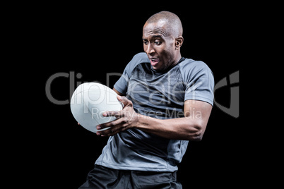 Sportsman catching rugby ball while playing