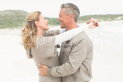 Smiling couple holding one another