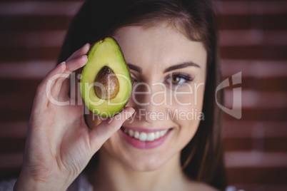 Woman showing fresh avocado