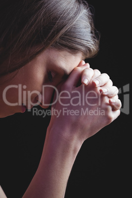 Woman praying with hands together