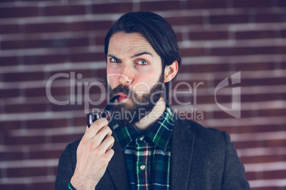 Portrait of serious man with smoking pipe