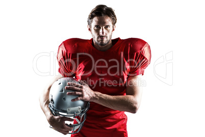 Confident American football player in red jersey holding helmet