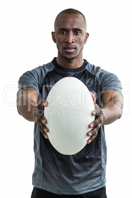 Portrait of sportsman showing rugby ball