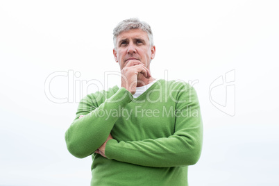 Smiling man standing at the shoreline