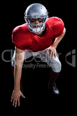 American football player taking position while playing