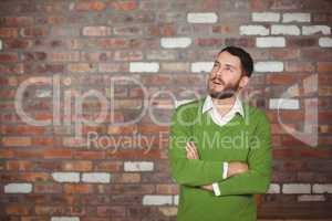 Young thoughtful businessman standing in office