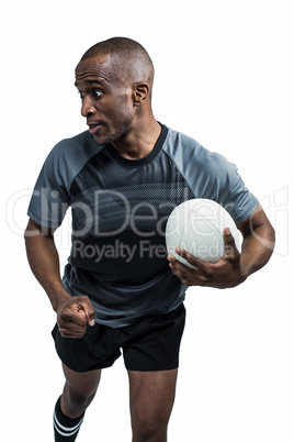 Sportsman running with clenched fist while holding rugby ball