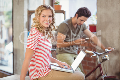 Portrait of businesswoman with laptop in office